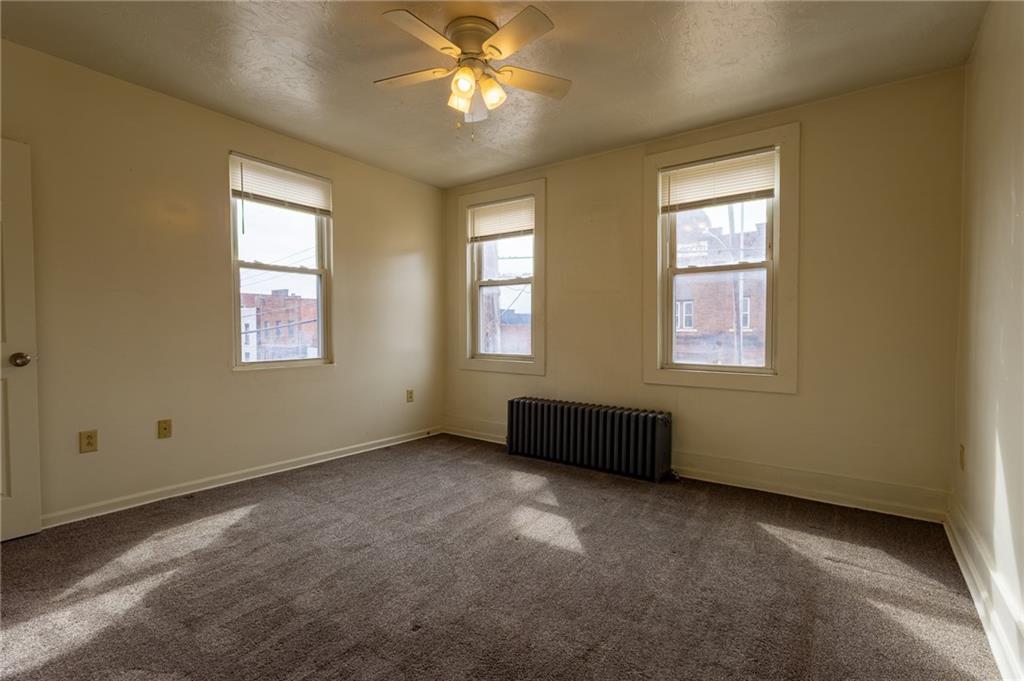832 Broadway Avenue McKees Rocks, PA 15136 - Photo 8 of 48 an empty room with windows and chandelier fan
