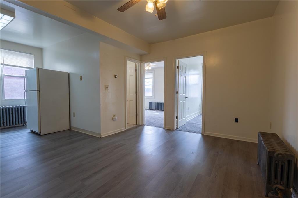 832 Broadway Avenue McKees Rocks, PA 15136 - Photo 10 of 48 an empty room with wooden floor chandelier and windows