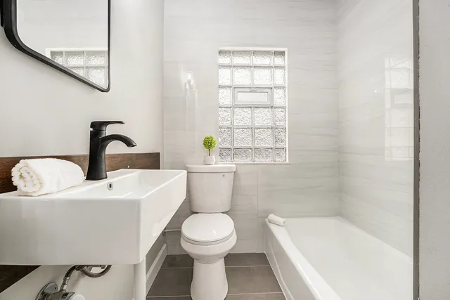 a bathroom with a toilet a sink and bathtub