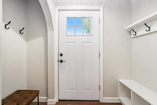 a view of bathroom with a small mirror