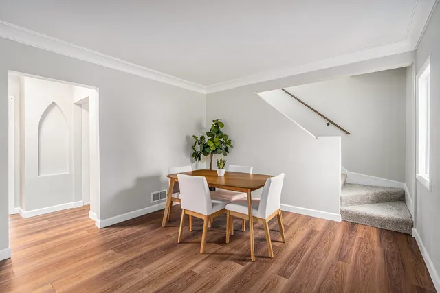 a view of a dining room with furniture and wooden floor