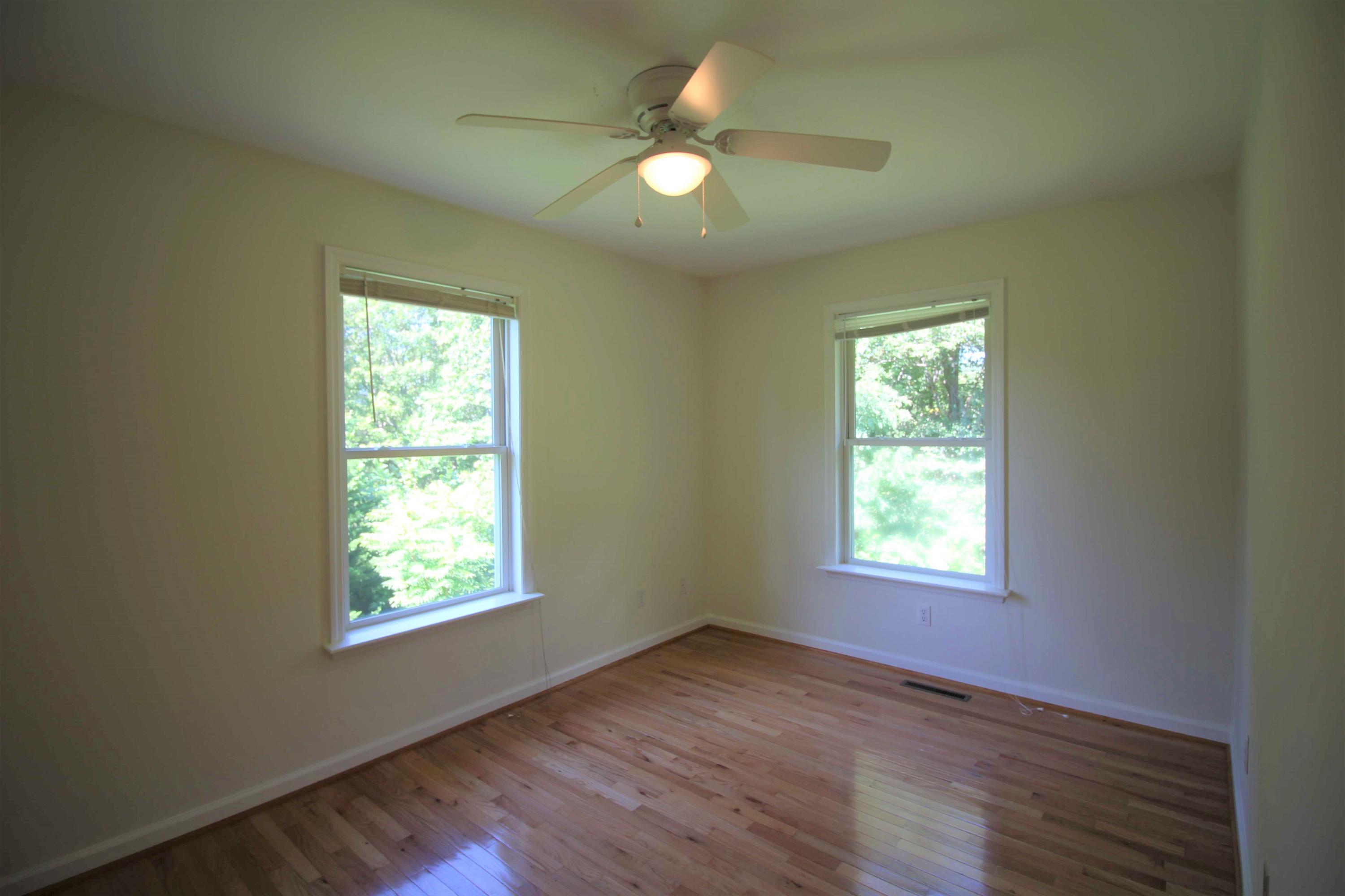 415 Green Level Road Boones Mill, VA 24065 - Photo 13 of 48 an empty room with wooden floor and windows