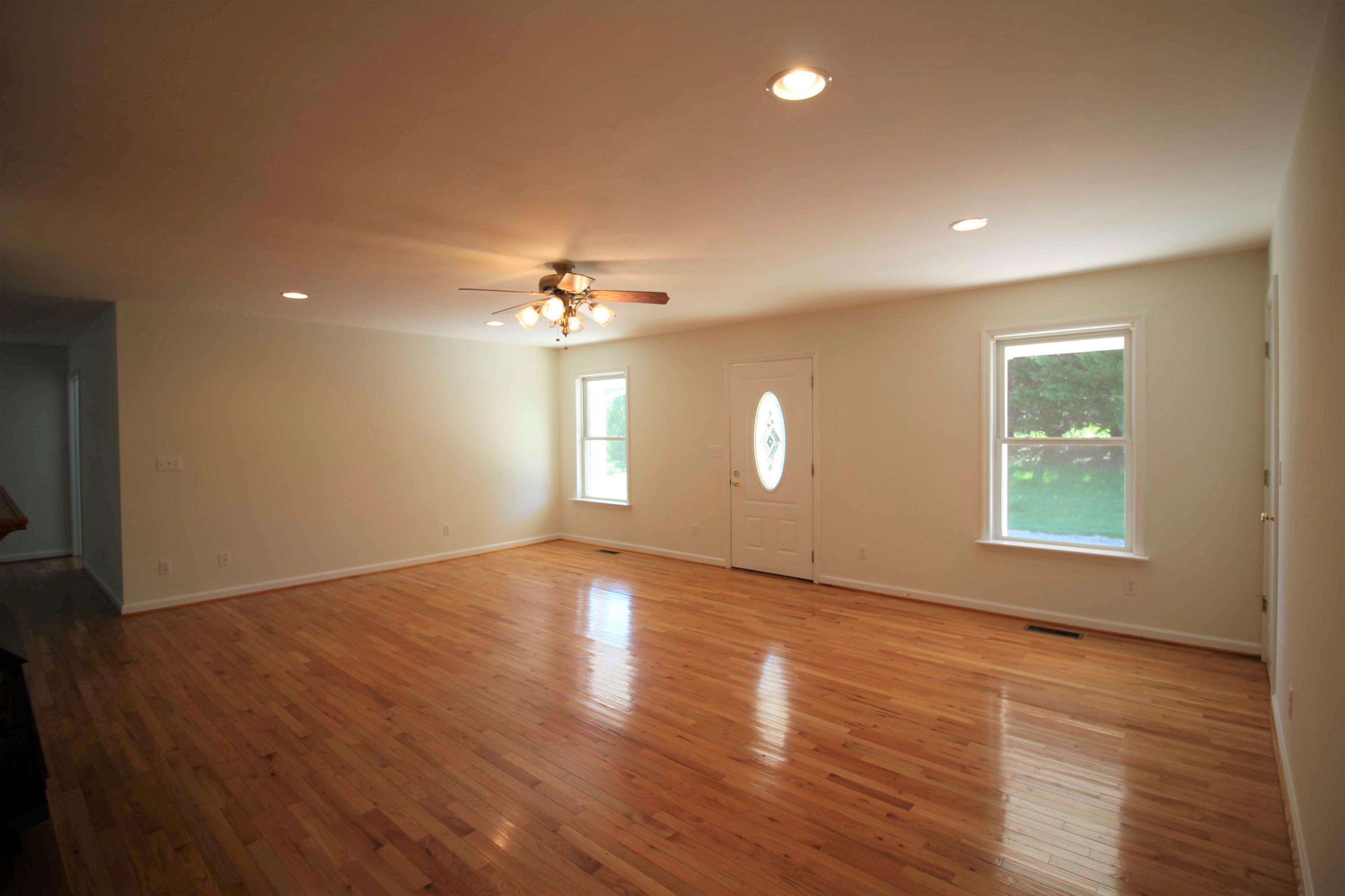 415 Green Level Road Boones Mill, VA 24065 - Photo 3 of 48 an empty room with wooden floor and windows