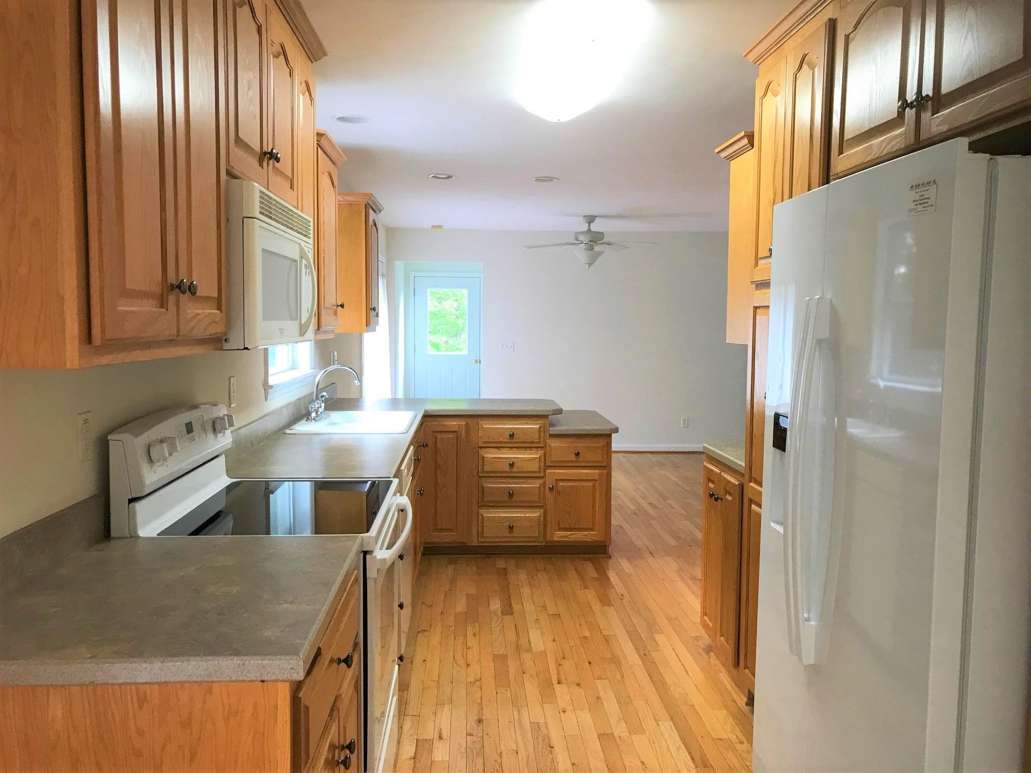 415 Green Level Road Boones Mill, VA 24065 - Photo 6 of 48 a kitchen with stainless steel appliances granite countertop a refrigerator and a stove