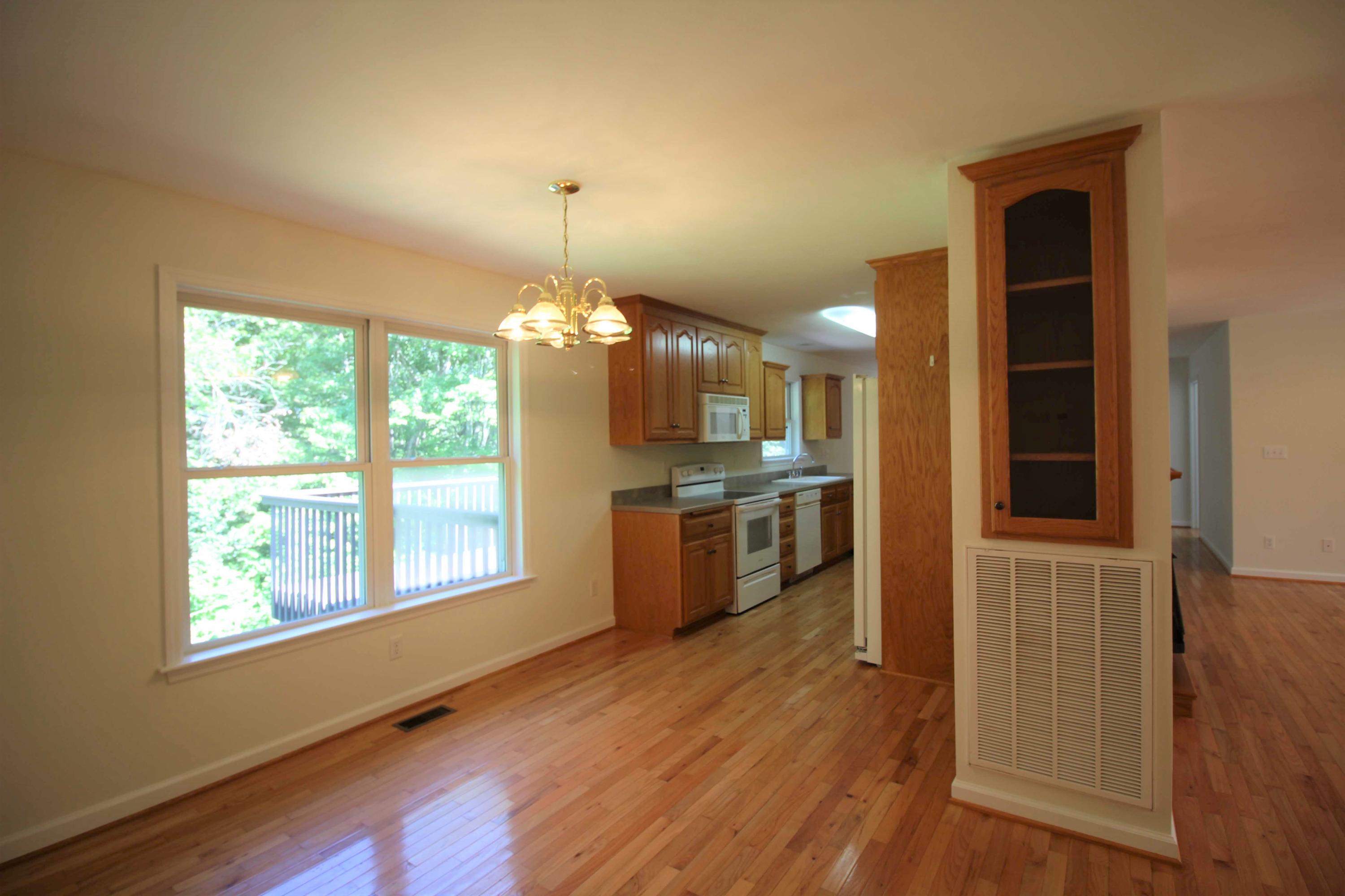 415 Green Level Road Boones Mill, VA 24065 - Photo 7 of 48 a view of a kitchen with refrigerator and wooden floor