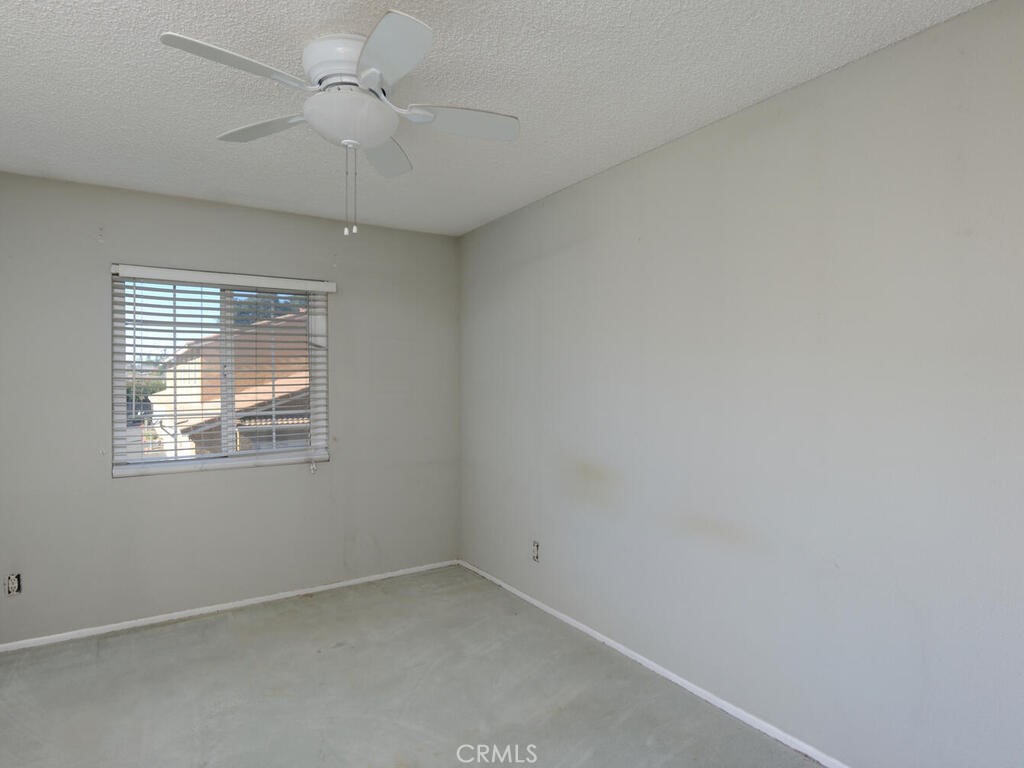 10074 Base Line Road Rancho Cucamonga, CA 91701 - Photo 11 of 18 an empty room with a window and a fan