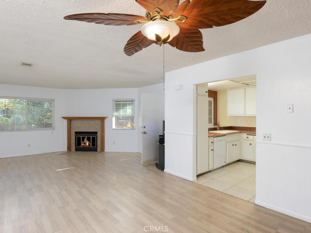 10074 Base Line Road Rancho Cucamonga, CA 91701 - Photo 3 of 18 a view of a kitchen with an empty space and a fireplace