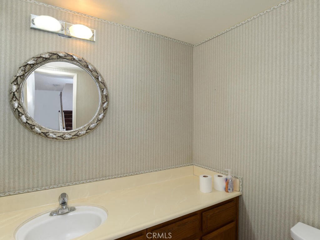 10074 Base Line Road Rancho Cucamonga, CA 91701 - Photo 10 of 18 a bathroom with a sink mirror vanity and toilet