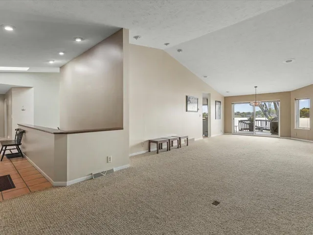 a living room with furniture and a flat screen tv with wooden floor