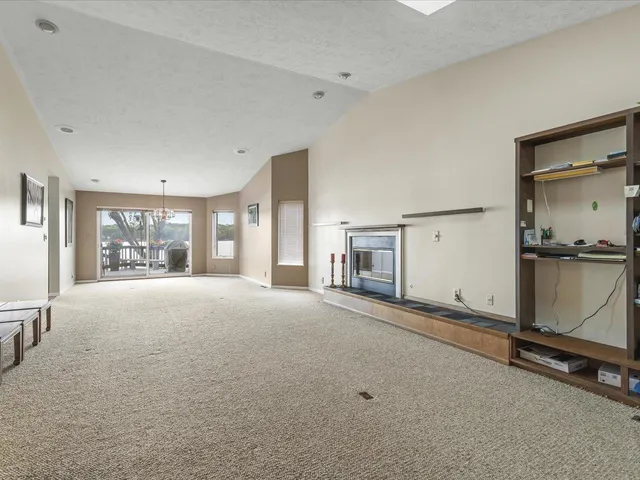 a living room with furniture and a floor to ceiling window
