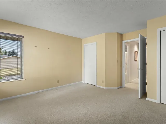 a bedroom with a large bed and a fireplace