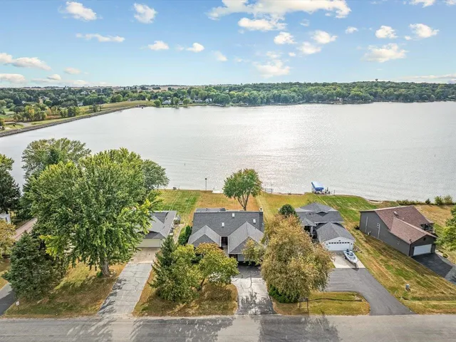an aerial view of ocean and residential houses with outdoor space and ocean view