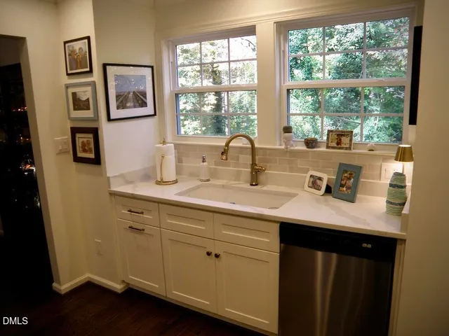 a kitchen with a sink cabinets and a window