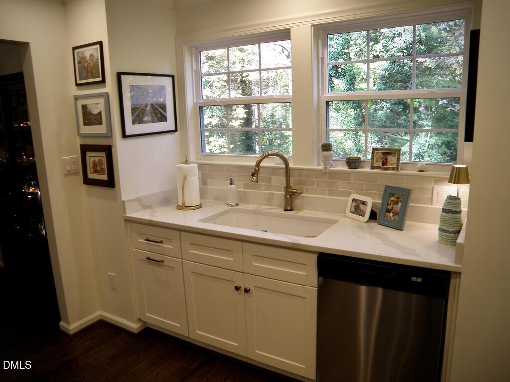 2858 Wycliff Road Raleigh, NC 27607 - Photo 12 of 26 a kitchen with a sink cabinets and a window