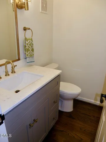 a bathroom with a sink a toilet and mirror