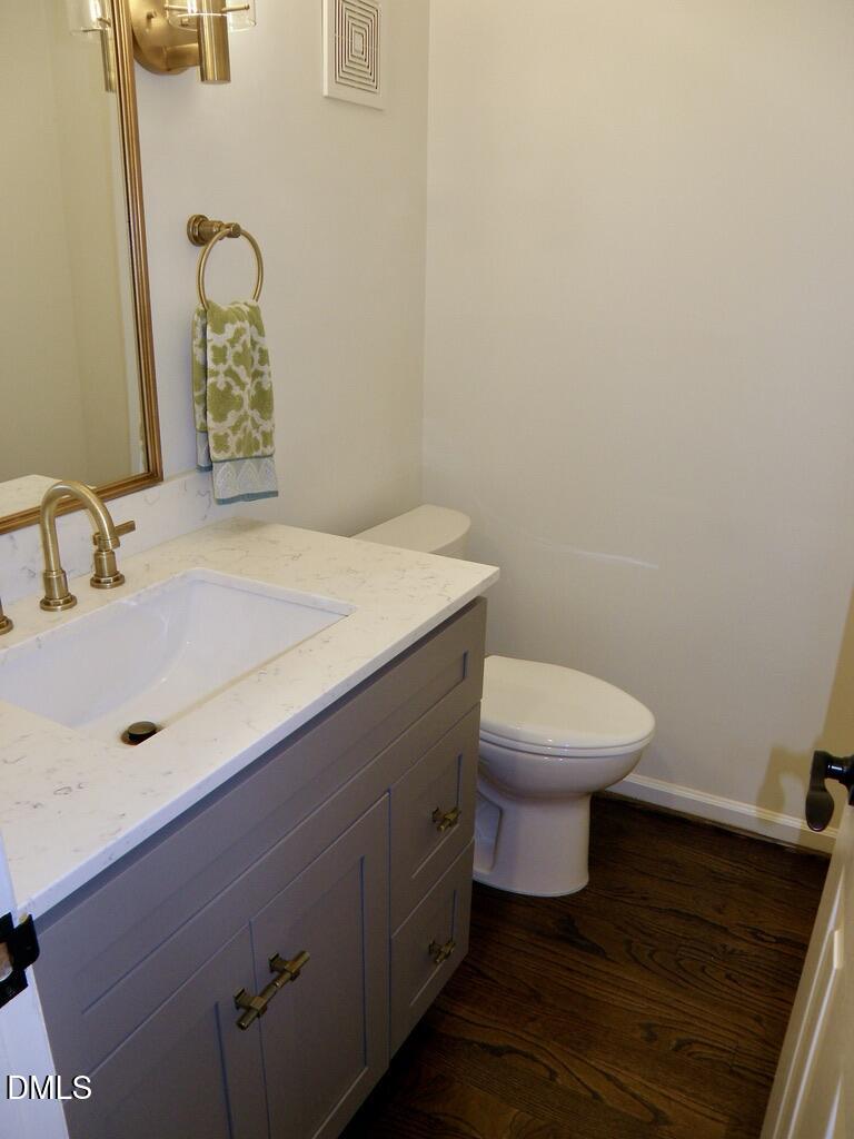 2858 Wycliff Road Raleigh, NC 27607 - Photo 14 of 26 a bathroom with a sink a toilet and mirror