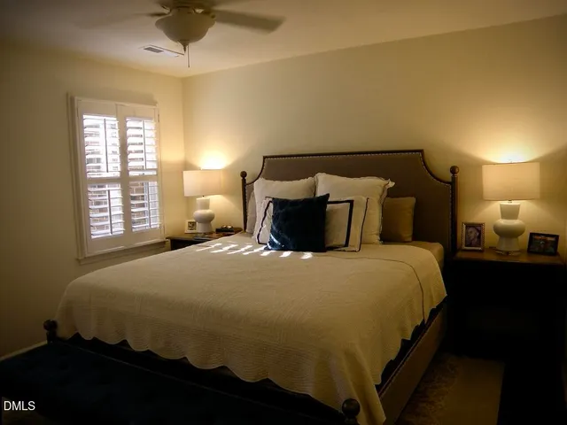 a bedroom with a bed and a lamp