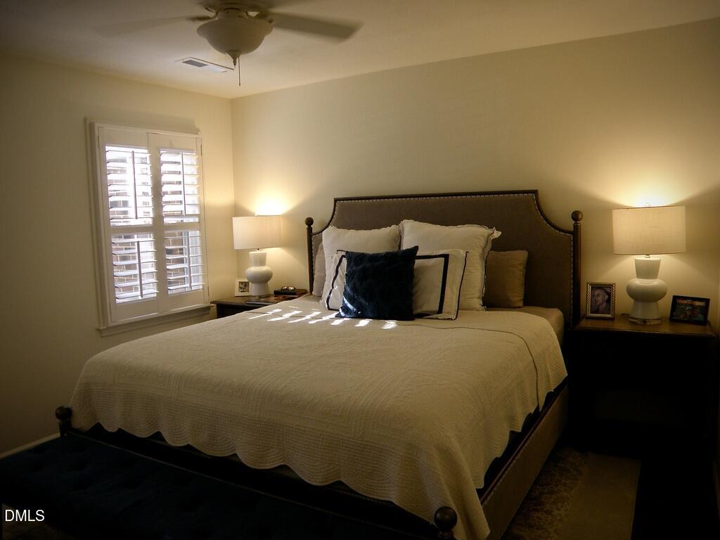 2858 Wycliff Road Raleigh, NC 27607 - Photo 15 of 26 a bedroom with a bed and a lamp