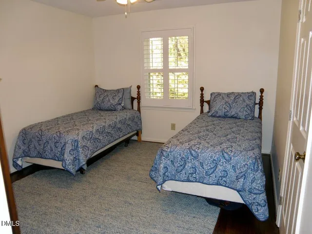 a living room with a bed and a couch next to a window