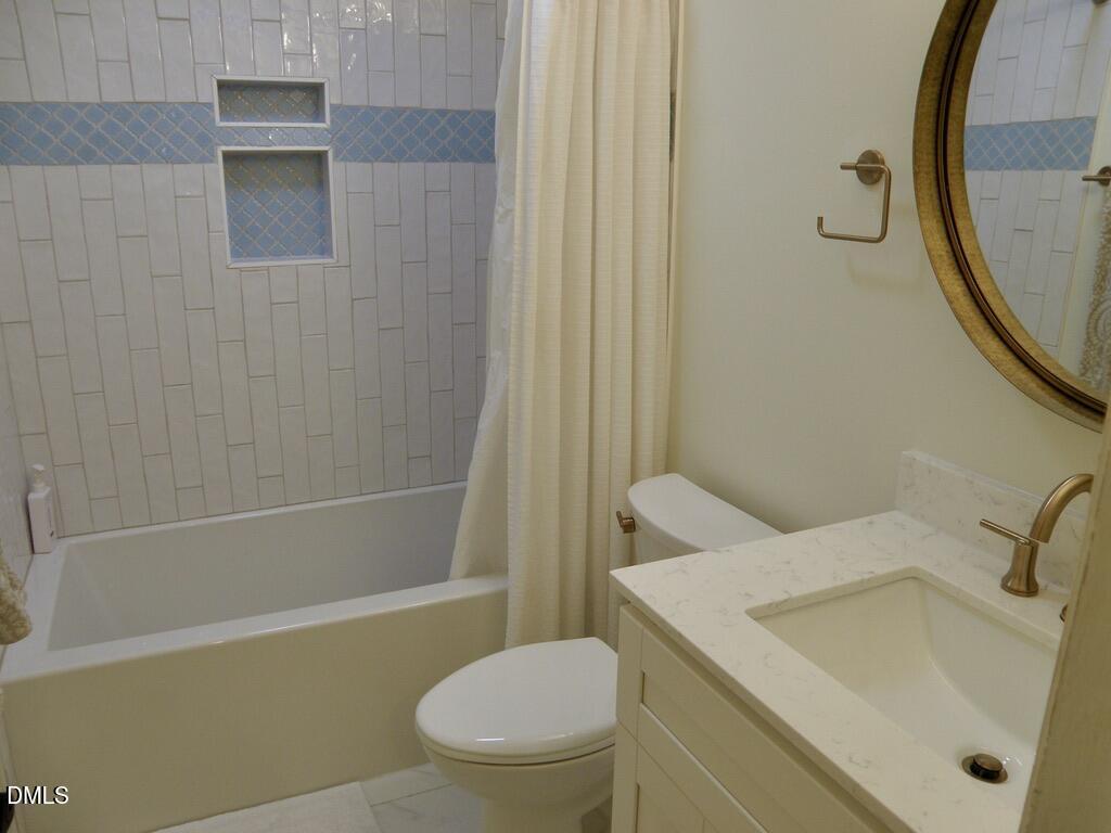 2858 Wycliff Road Raleigh, NC 27607 - Photo 19 of 26 a bathroom with a sink a toilet and shower