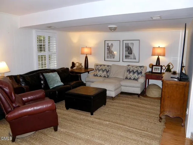 a living room with furniture and a lamp
