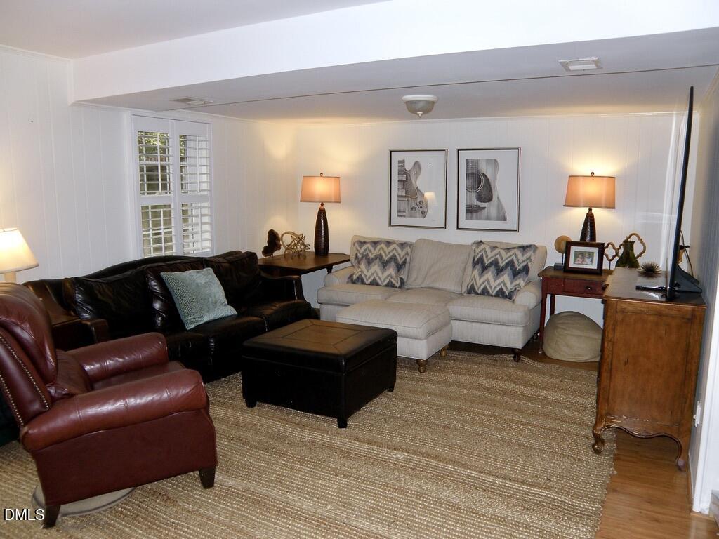2858 Wycliff Road Raleigh, NC 27607 - Photo 21 of 26 a living room with furniture and a lamp
