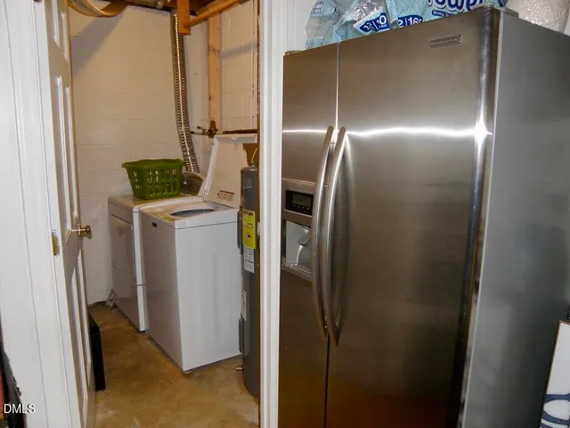 a kitchen with a refrigerator and mirror