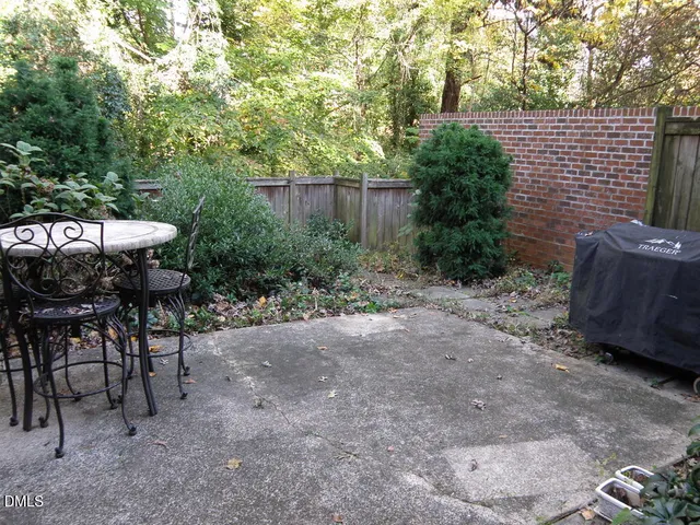 a view of backyard with outdoor seating and trees