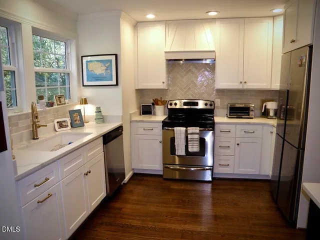 a kitchen with a sink stove and cabinets