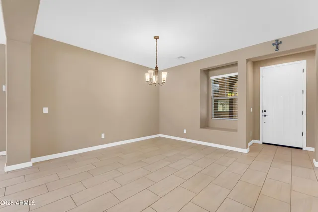 a view of a livingroom with a ceiling fan and window