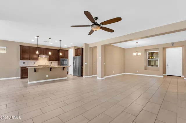 a kitchen with granite countertop a sink a counter top space appliances and cabinets