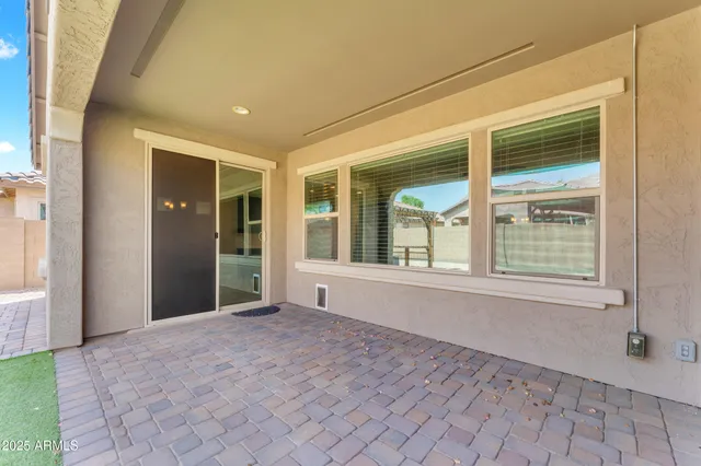 a view of a house with a yard and a patio