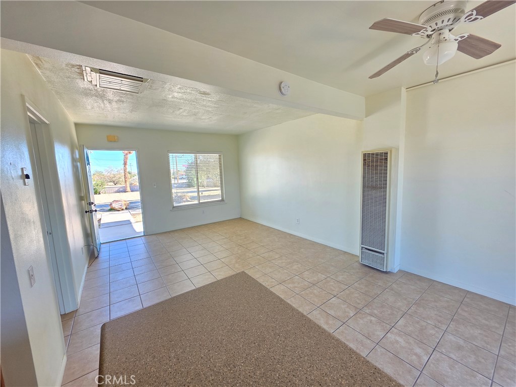 73636 Cactus Drive, Unit A Twentynine Palms, CA 92277 - Photo 5 of 8 wooden floor in an empty room with a window
