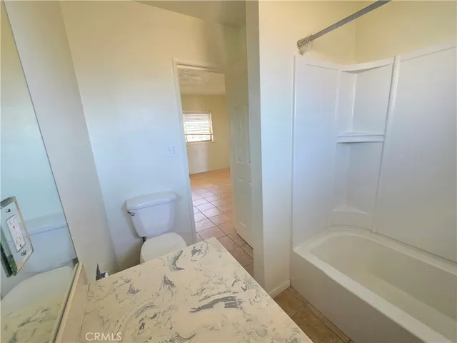 a bathroom with a bathtub sink and toilet