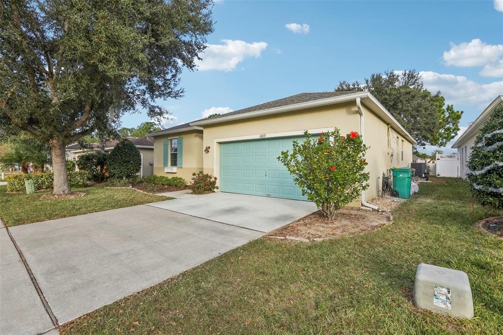 a view of a house with a yard and garage