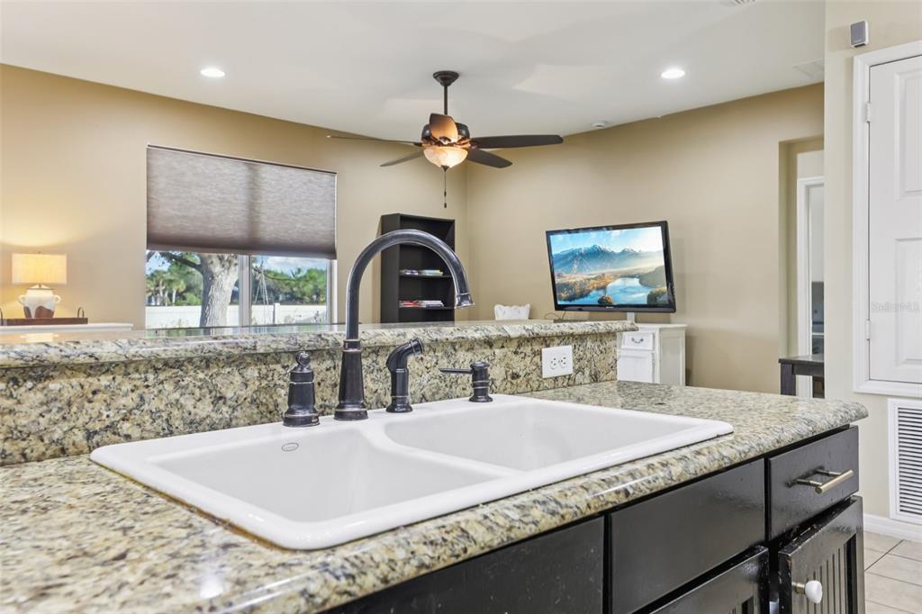 1689 Strathmore Circle Mount Dora, FL 32757 - Photo 12 of 37 a kitchen with a table a chandelier and living room