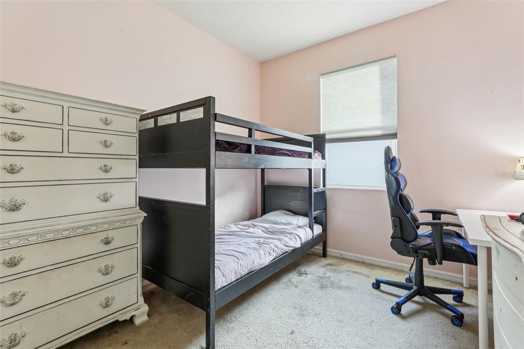 1689 Strathmore Circle Mount Dora, FL 32757 - Photo 21 of 37 a bedroom with a bed and a closet
