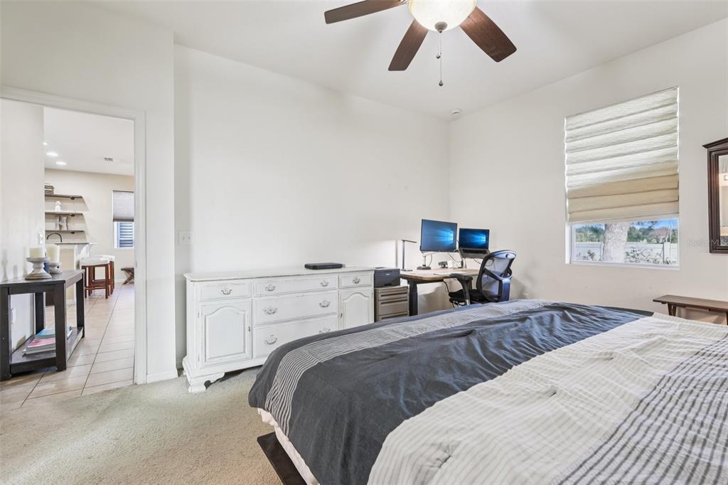 1689 Strathmore Circle Mount Dora, FL 32757 - Photo 25 of 37 a bedroom with a bed and furniture