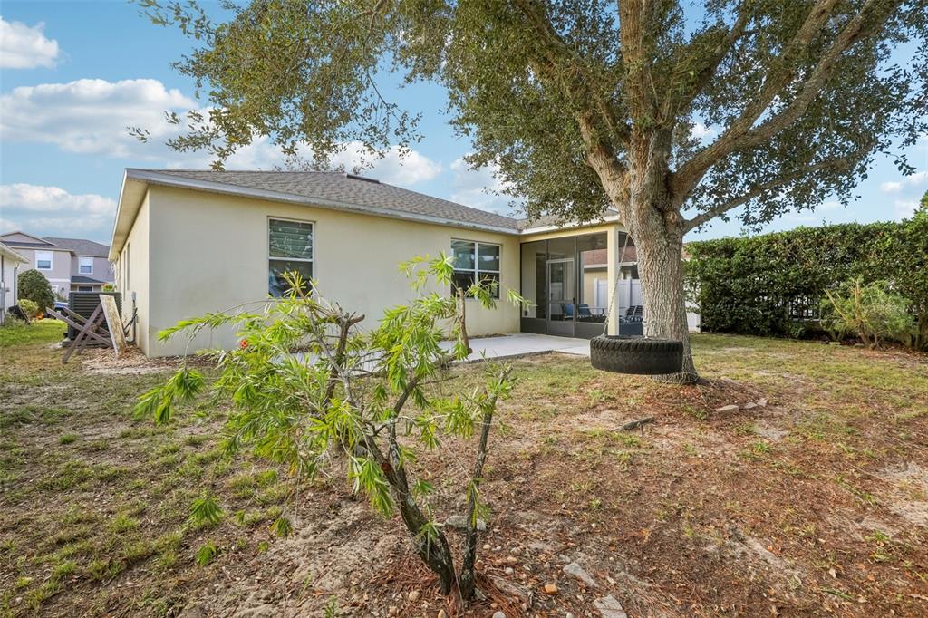 1689 Strathmore Circle Mount Dora, FL 32757 - Photo 32 of 37 a backyard of a house with yard and outdoor seating