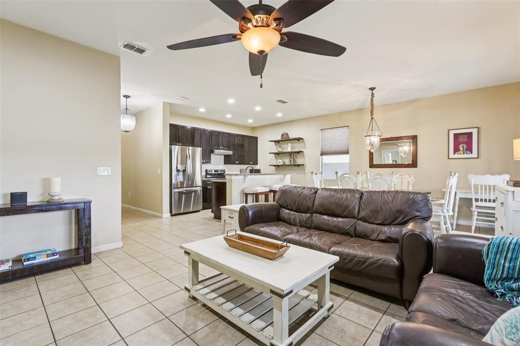 1689 Strathmore Circle Mount Dora, FL 32757 - Photo 5 of 37 a living room with furniture and kitchen view
