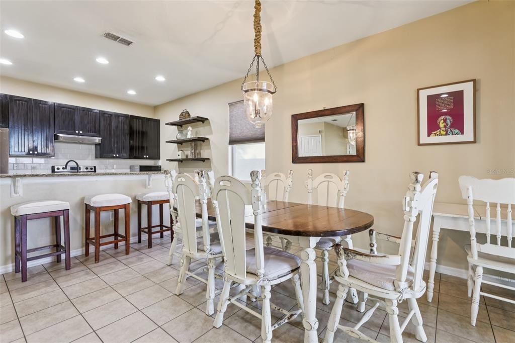 1689 Strathmore Circle Mount Dora, FL 32757 - Photo 7 of 37 a dining room with kitchen island furniture a dining table and chairs