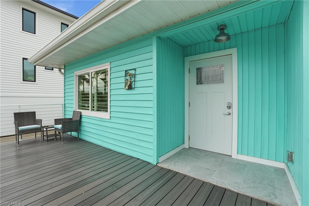 270 Dundee Road Fort Myers Beach, FL 33931 - Photo 4 of 48 Property entrance featuring a wooden deck - Virtually Edited Image