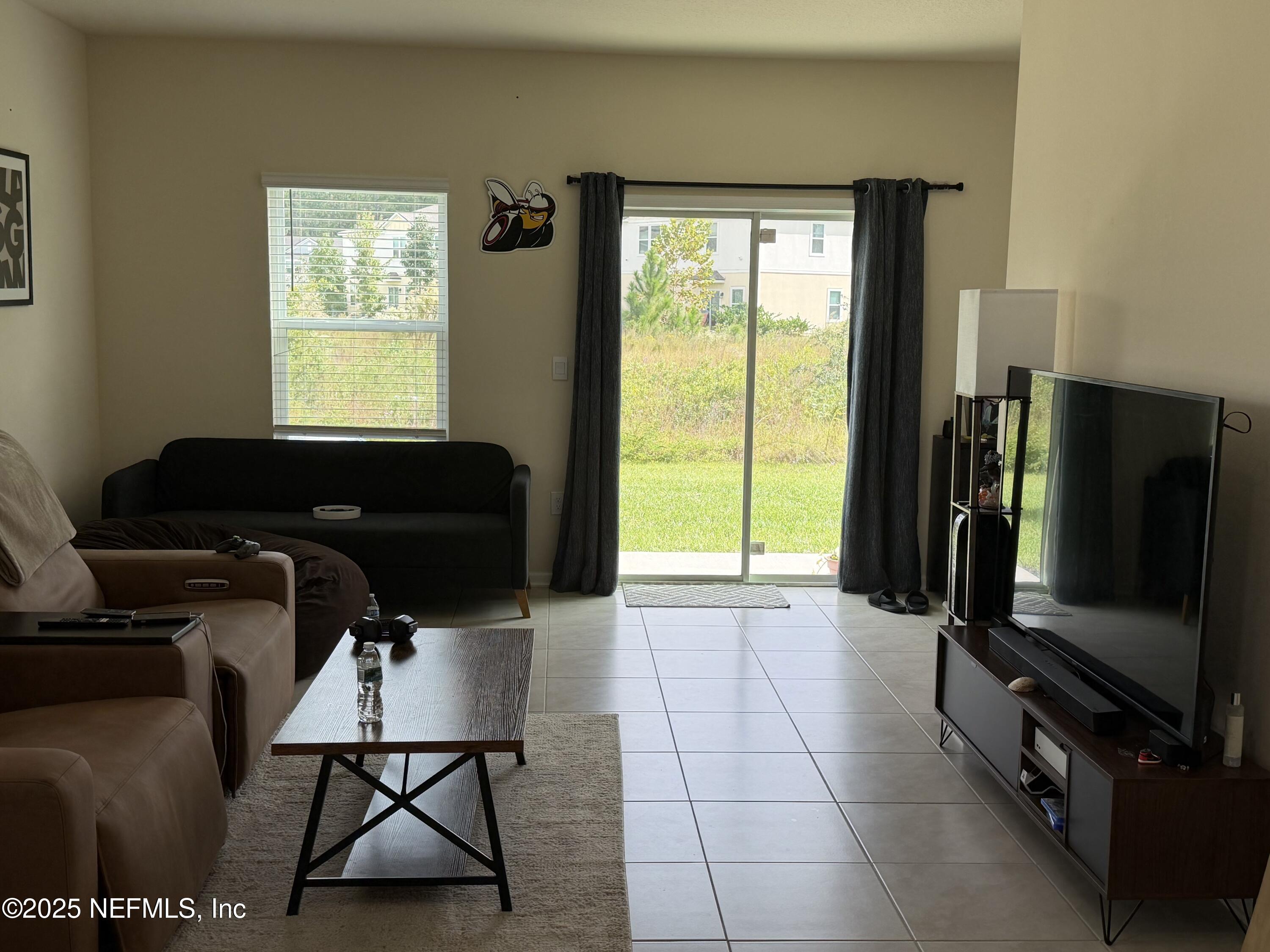 64 Java Lane St. Augustine, FL 32092 - Photo 14 of 38 a living room with furniture and a flat screen tv