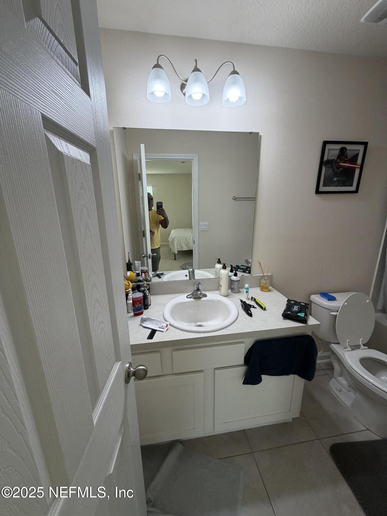 64 Java Lane St. Augustine, FL 32092 - Photo 21 of 38 a bathroom with a sink and a mirror