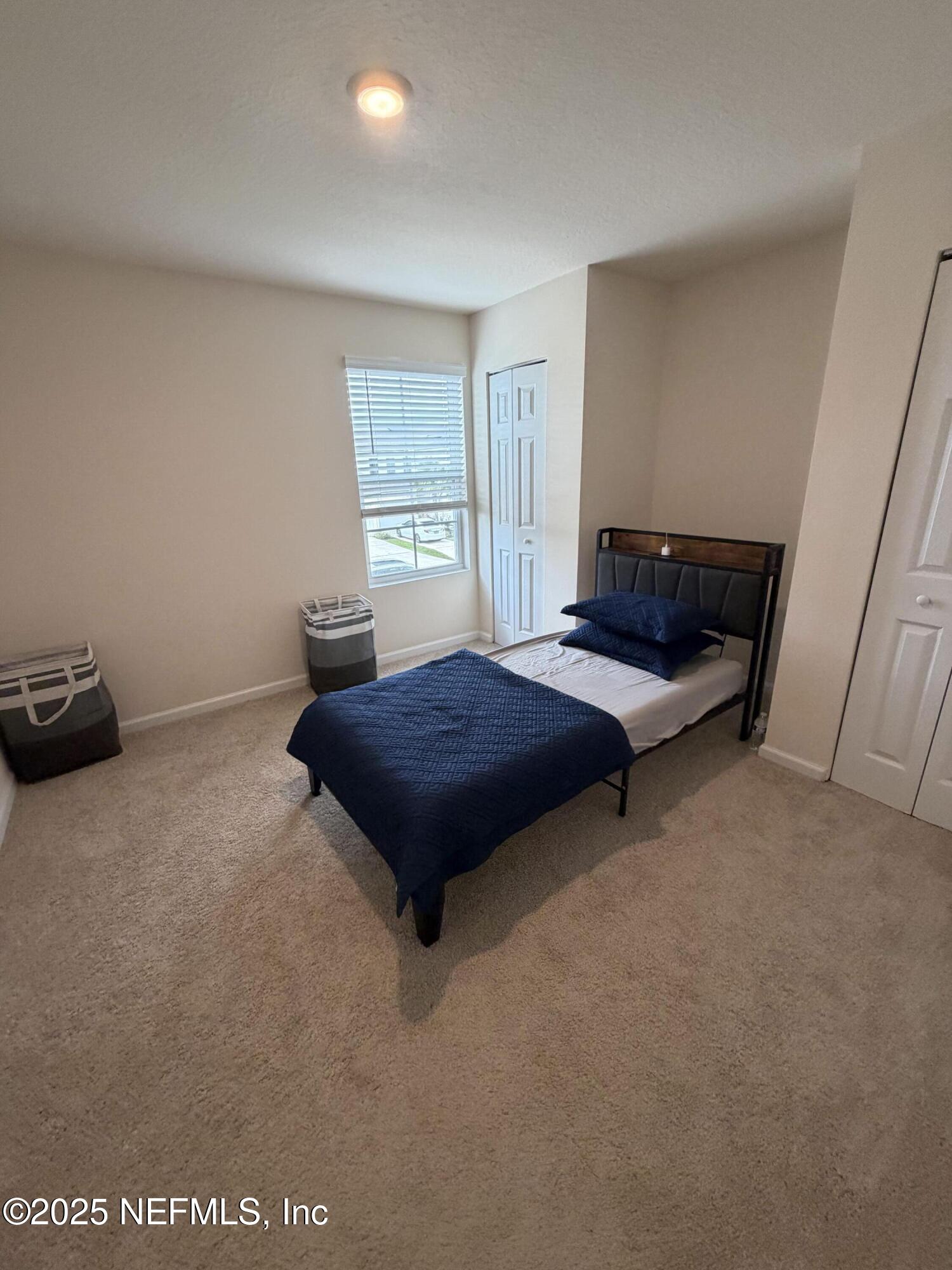 64 Java Lane St. Augustine, FL 32092 - Photo 25 of 38 a bedroom with a bed and window