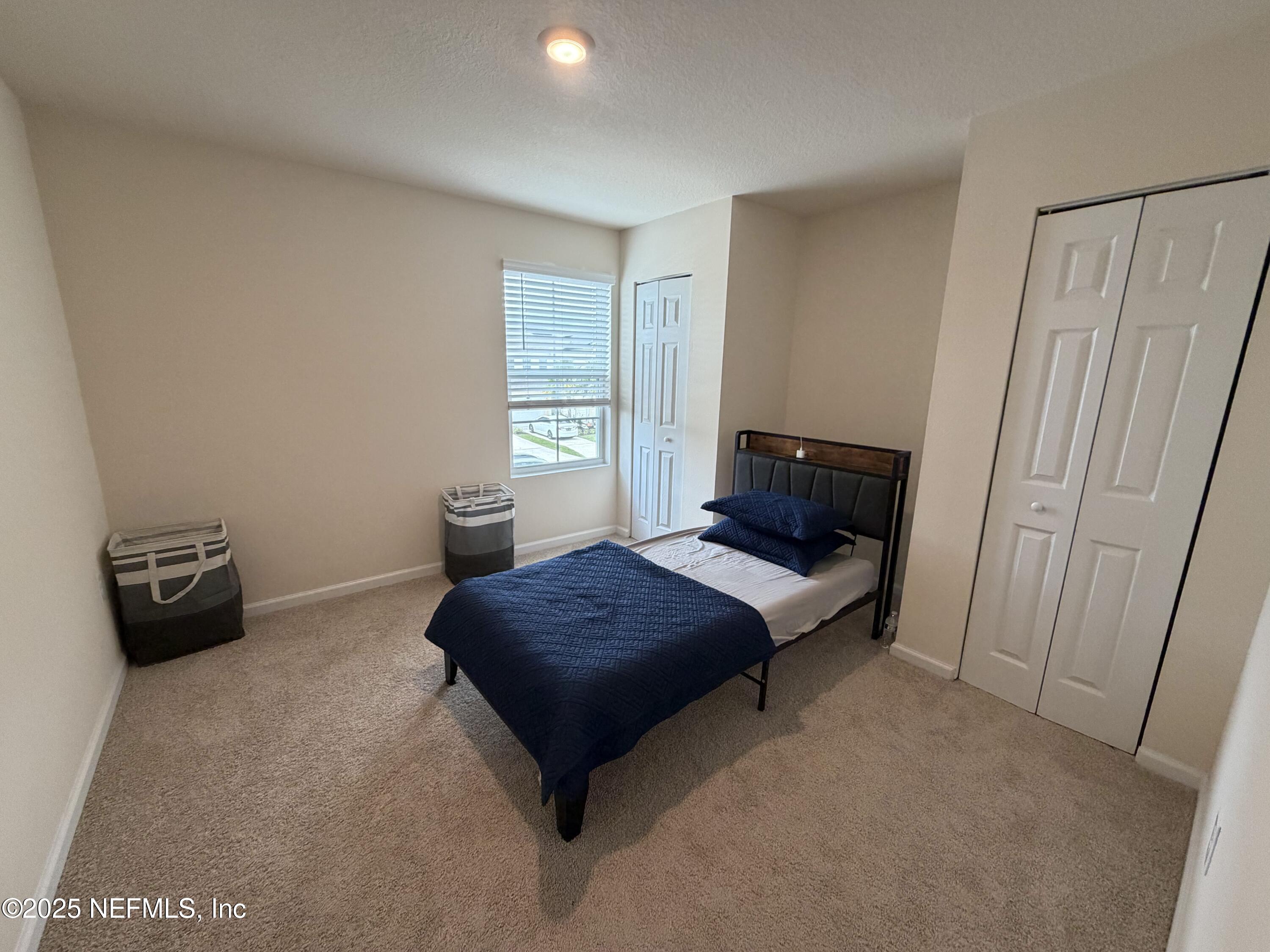 64 Java Lane St. Augustine, FL 32092 - Photo 26 of 38 a bedroom with a bed and a window