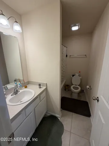 a view of a backyard with fountain plants and large trees