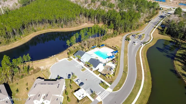 an aerial view of a swimming pool with lawn chairs and plants
