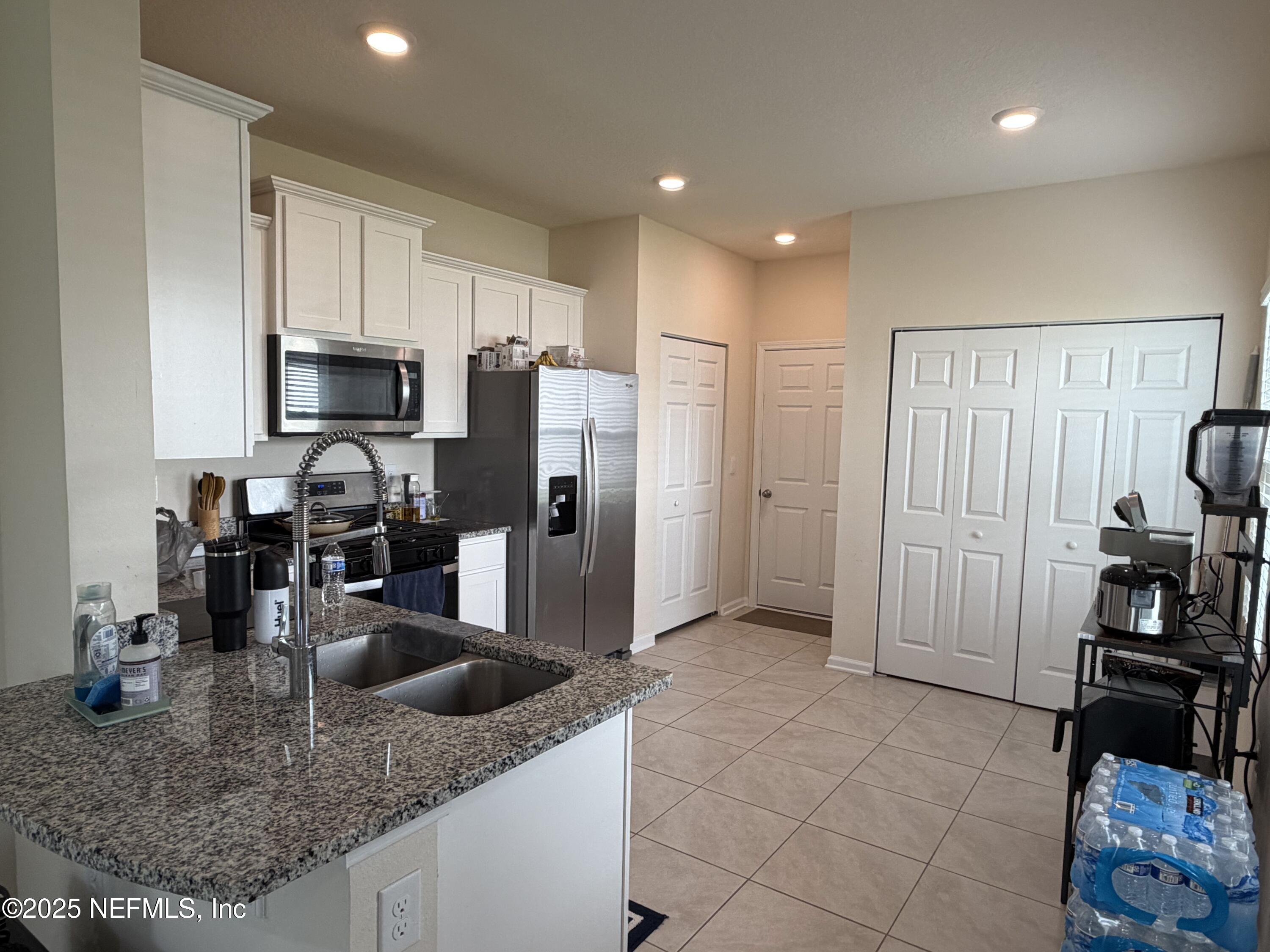 64 Java Lane St. Augustine, FL 32092 - Photo 4 of 38 a kitchen with stainless steel appliances granite countertop a sink refrigerator and cabinets