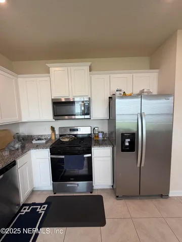 a kitchen with granite countertop a sink and cabinets